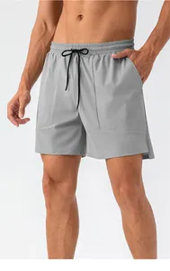 Dettaglio dei pantaloncini sportivi da uomo con elastico in vita e coulisse nera a contrasto