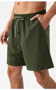 Detail of olive green quick-dry shorts featuring elastic drawstring waist and side pockets