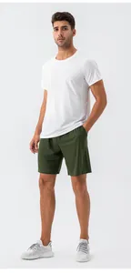 Men's athletic outfit with white breathable T-shirt and olive green drawstring shorts