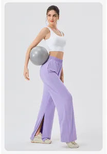 Detail shot of high-waisted split hem wide leg yoga pants in light purple with a white tank