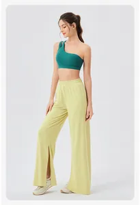 Detail of high-waisted loose yoga pants with side split hem and breathable fabric