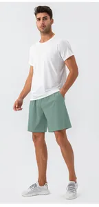 Full view of men's quick-dry sports outfit with white t-shirt and green gym shorts