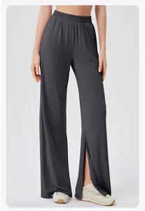Detail of high waisted wide leg gym pants with side slits and elastic waistband