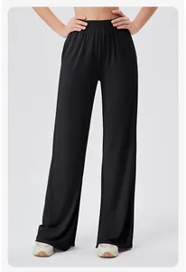Detail of high-waisted wide-leg yoga pants featuring a comfortable elastic waistband in black