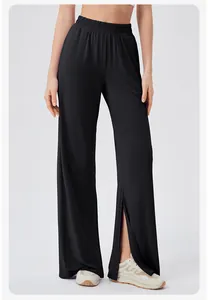 Detail view of high waisted black wide leg yoga pants with elegant side split leg openings