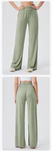 Detail view of high waist loose yoga pants in light green featuring side slit design