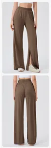 Detail view of high-waisted wide leg yoga pants featuring a side slit and elastic waistband