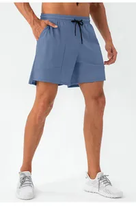 Detail of fog blue men's athletic shorts featuring elastic waist and contrast drawstring