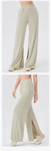 Detailed side view of beige wide-leg yoga pants with high waist and side slits