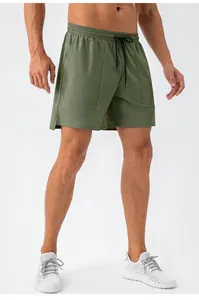 Detail of army green sports shorts with elastic waistband and black drawstring