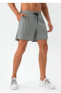 Detailed view of gray athletic shorts featuring elastic waistband and black drawstrings