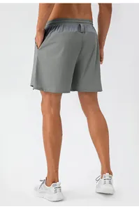 Rear view of men's gray sports shorts showing breathable mesh panel and elastic waistband
