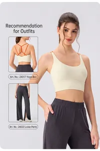 Detail of light yellow yoga bra with thin cross straps and grey split hem loose pants
