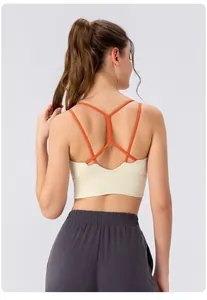 Detail view of women's sports bra featuring orange thin straps and racerback design