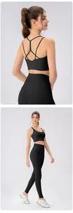 Detail of black sports bra with criss-cross back straps and high-waisted yoga leggings