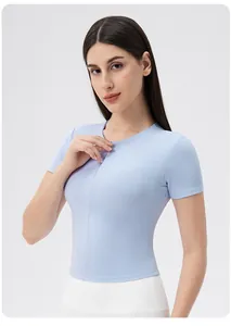 Detailed close-up of light blue yoga top with front zipper and athletic crew neck