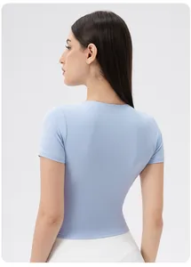 Close-up of a light blue yoga top featuring back contours and ergonomic shoulder cutouts