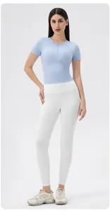 Detail view of light blue yoga top with front zipper and slim-fit athletic design
