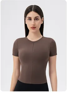 Close-up of the front half-zipper design on a brown slim-fit women's yoga shirt