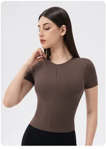 Close-up of women's mocha sports top featuring a front zipper and seamless ribbed texture