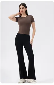 Detail of slim-fit yoga top with hidden front zipper and high-waist flared pants