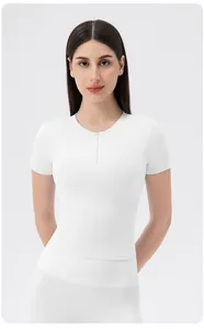 Close-up of white yoga top with front zipper detail and premium stretch fabric texture