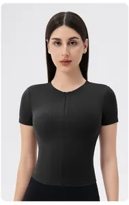 Close-up of women's black yoga top featuring front zipper detail and high-stretch fabric