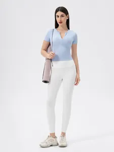 Women's light blue zip-front yoga tee and white high-waist leggings fitness set