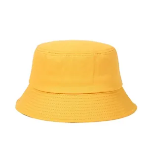 Close-up of bright yellow cotton bucket hat showing detailed reinforced stitching on the brim