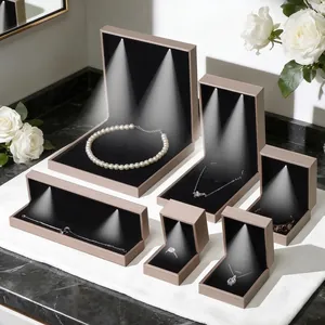 Champagne gold LED jewelry box set with black velvet interior for rings and necklaces