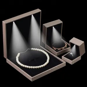 Luxury champagne gold LED jewelry boxes with black velvet lining for rings and necklaces