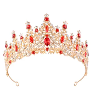 Detailed front view of a gold bridal crown with red crystals and white rhinestones