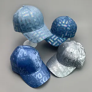 Detail of baseball caps showing iridescent Queen prints and 3D embossed lettering
