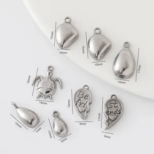 Detailed view of assorted DIY vintage silver charms including turtle and best friend heart shapes