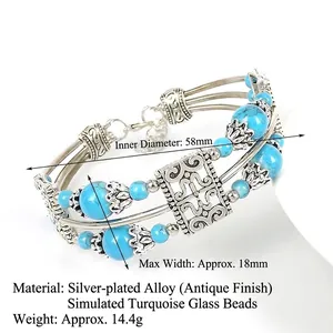 Detail of bohemian silver-plated alloy bracelet with blue glass beads and hollow metal charm