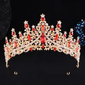 Luxurious gold alloy bridal crown with red rhinestones and crystals on black background