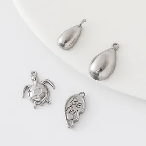 DIY stainless steel jewelry pendant set including sea turtle and heart charms on white background