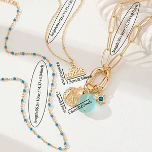 Three-layer gold beach necklace set with starfish, sea shells and blue bead details