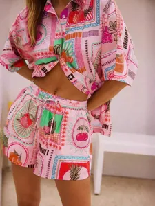 Close-up of tropical fruit print fabric on summer pink short set with button shirt and shorts