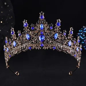Detailed close-up of a vintage bronze bridal crown with dark blue gems and black rhinestones
