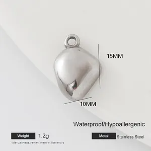 Macro view of a 15mm silver stainless steel heart pendant with precise measurements