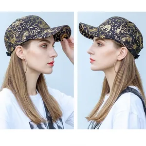 Black cotton baseball cap with gold graffiti print featuring heart and love patterns