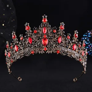 Close-up of vintage bronze tiara with intricate floral patterns and red teardrop gems