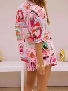Detailed view of the vibrant pink fruit print fabric on the summer shirt and shorts set