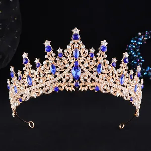Detail of baroque gold alloy crown with large blue pear-shaped rhinestones and floral hollow design