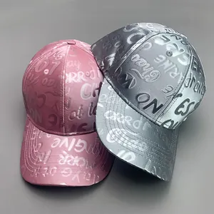 Detail of pink and silver reflective baseball caps with embossed alphabet texture
