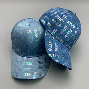 Detail of light blue denim baseball caps with reflective rainbow QUEEN letter print