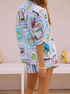 Detail of light blue summer two-piece set featuring tropical fruit prints and woven texture