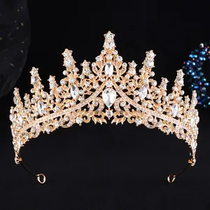 Close-up of golden bridal crown with intricate hollow patterns and sparkling crystals