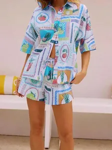 Detail of summer two-piece set featuring fruit tile prints on shirt and drawstring shorts
